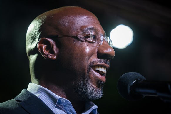 epa10350900 US Democratic Senate candidate Raphael Warnock campaigns at Wild Heaven West End Brewery &amp; Gardens in Atlanta, Georgia, USA, 05 December 2022. Warnock, a current US Senator, is in a ru ...