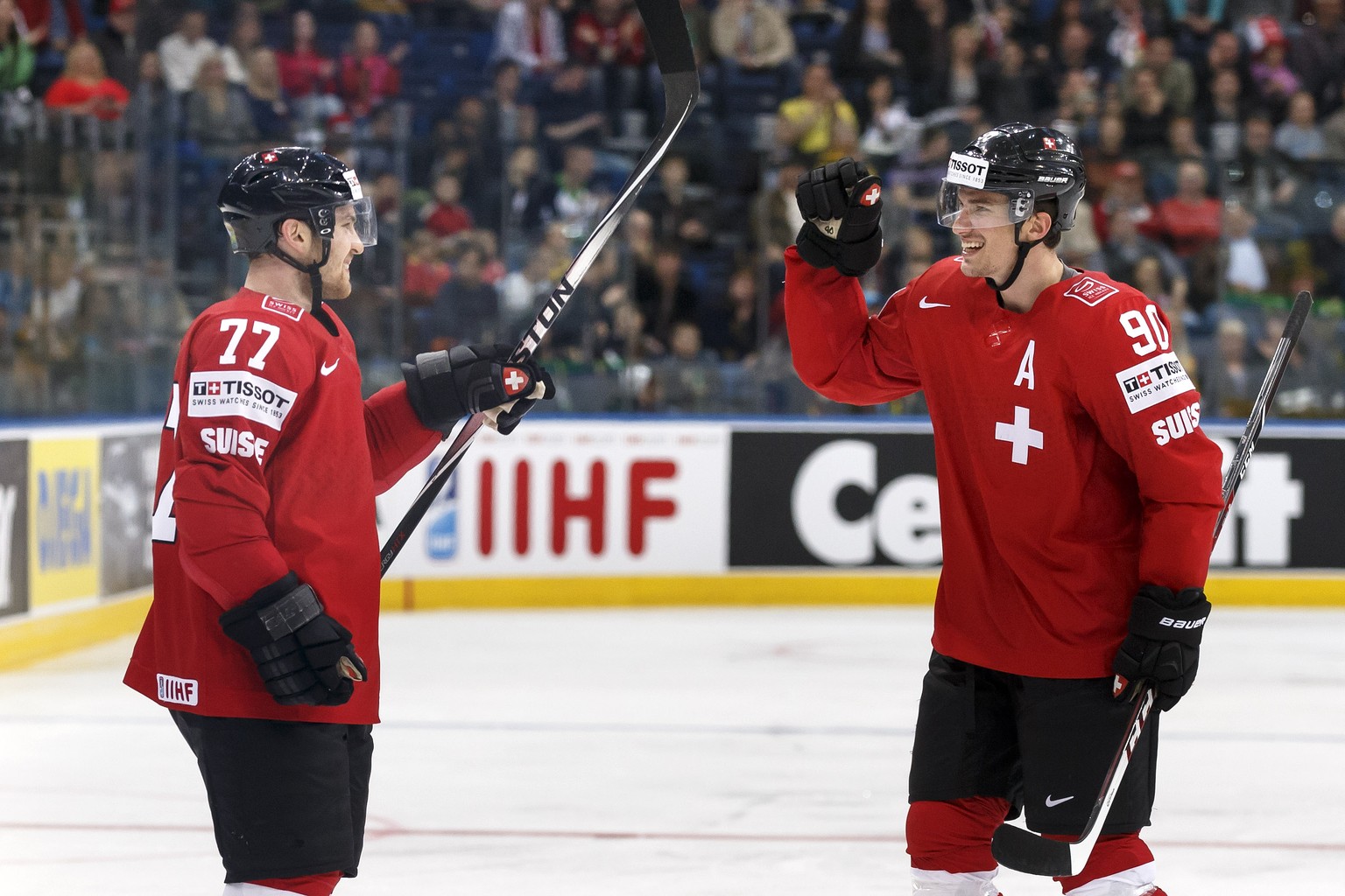Switzerland&#039;s Yannick Weber, left, celebrates his goal with teammate Roman Josi, right, after scoring the 3:0, during the 2014 IIHF Ice Hockey World Championships preliminary round game Switzerla ...