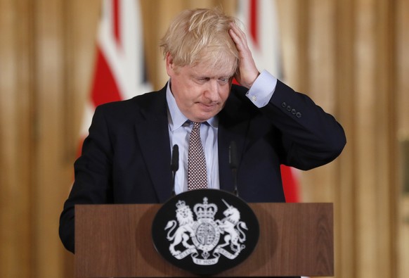 FILE - Britain&#039;s Prime Minister Boris Johnson reacts during a press conference at Downing Street on the government&#039;s coronavirus action plan in London on March 3, 2020. For Boris Johnson, fa ...