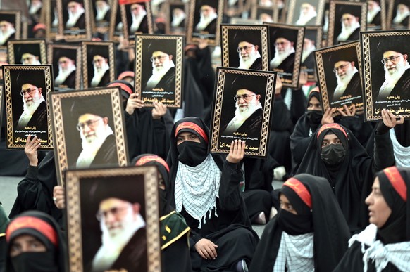 epa12727842 Pakistani Shiite Muslims hold placards and banners during a rally to show solidarity with Iran on the anniversary of Iran?s Islamic Revolution, in Lahore, Pakistan, 11 February 2026. The e ...