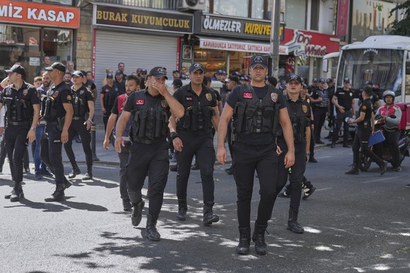 Turkish police officers walk as people gather and celebrate the annual LGBTQ+ Pride March, in Istanbul, Turkey, Sunday, June 29, 2025. (AP Photo/Dilara Acikgoz)
Turkey Pride March