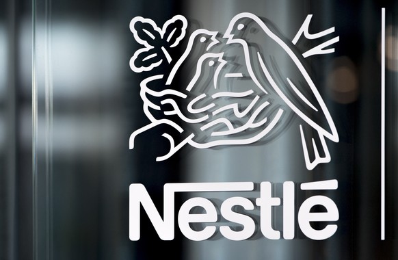 FILE - Nestle&#039;s logo is displayed on a window, during the 2018 full-year results press conference of the food and drinks giant Nestle, in Vevey, Thursday, Feb. 14, 2019. Global food giant Nestle, ...