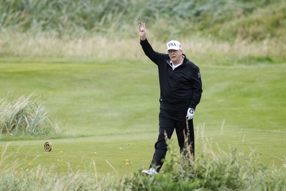 epa12265584 US President Donald J. Trump gestures as he speaks to the media while playing golf at Trump Turnberry golf course during a private visit in Turnberry, Scotland, Britain, 27 July 2025. US P ...