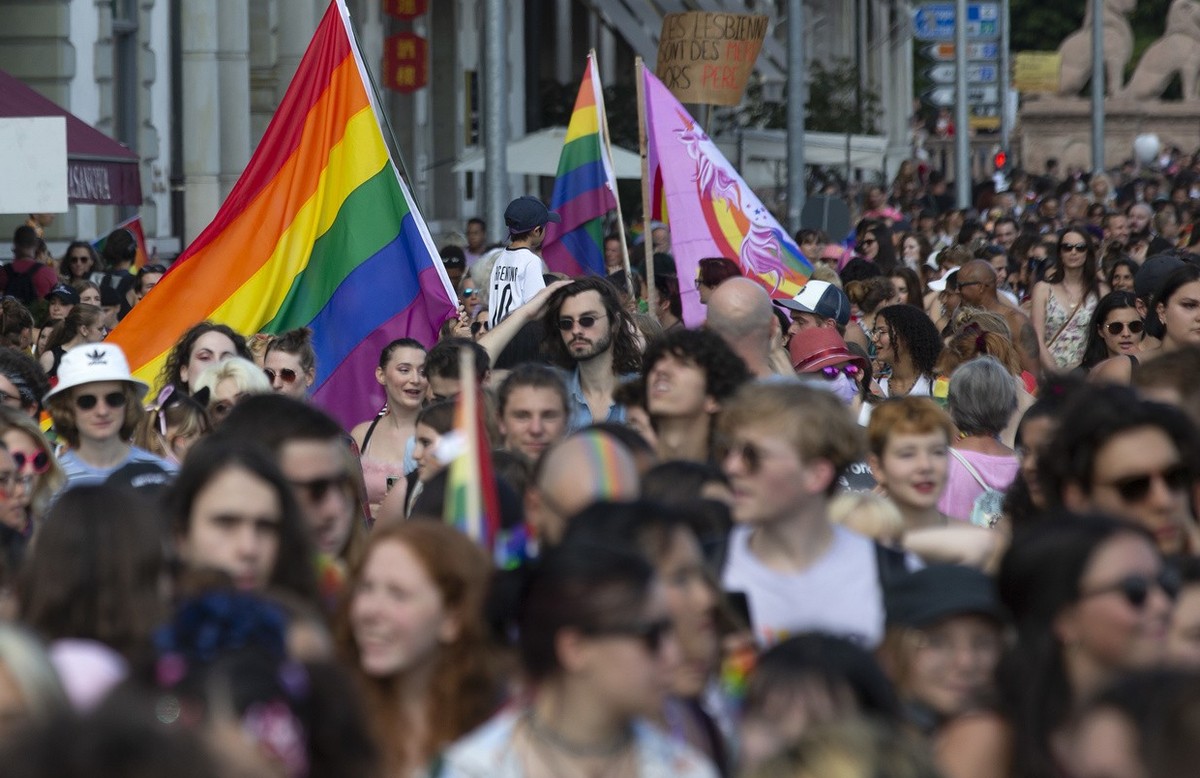 People walk through the streets for the rights of the LGBTIQ+ community during the Geneva Pride march, in Geneva, Switzerland, Saturday, September 11, 2021. (KEYSTONE/Salvatore Di Nolfi)