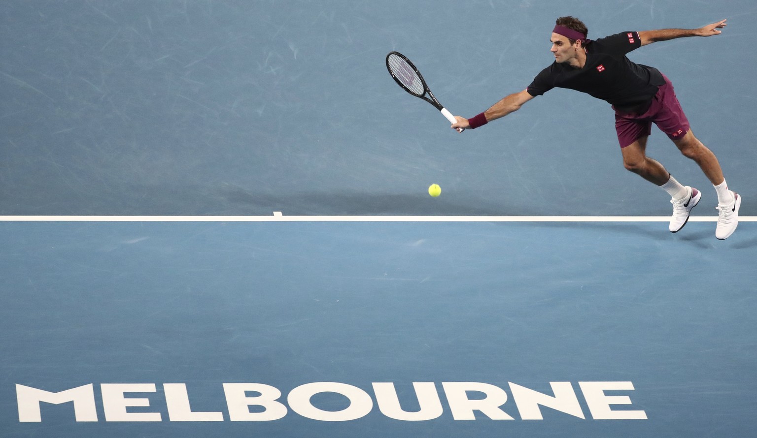 Switzerland's Roger Federer attempts to make a backhand return to Serbia's Novak Djokovic during their semifinal match at the Australian Open tennis championship in Melbourne, Australia, Thursday, Jan ...