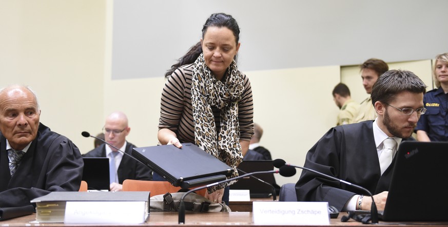 Defendant Beate Zschaepe arrives in the court room next to her lawyers Hermann Borchert , left, and Mathias Grasel, right, in Munich, Germany, Wednesday, July 19, 2017. Prosecutors have started their  ...