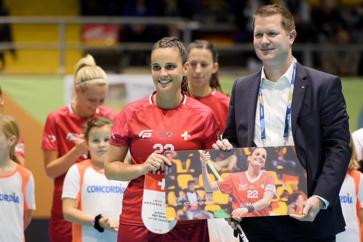 Roger Loetscher of Swiss Unihockey, right, gives a gift for the 100 games in the national team to Switzerland's Seraina Ulber, left, before, before the 12th Women's World Floorball Champions ...