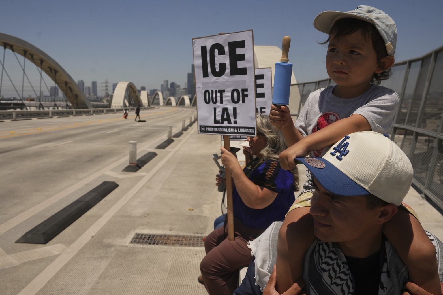 Demonstrators temporarily close the Sixth Street bridge after a rally at Hollenbeck Park calling for an end to the immigration raids by ICE in Los Angeles on Tuesday, July 1, 2025. (AP Photo/Damian Do ...