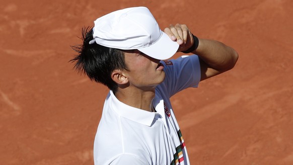 Japan&#039;s Kei Nishikori adjusts his cap as he plays Spain&#039;s Fernando Verdasco during their fourth round match of the French Open tennis tournament at the Roland Garros stadium, Monday, June 5, ...