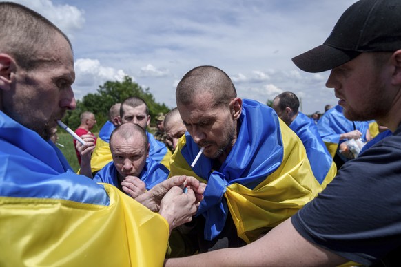 A Ukrainian serviceman shouts &quot;Glory to Ukraine&quot; after returning from captivity during POWs exchange in Sumy region, Ukraine, Friday, May 31, 2024. Ukraine returned 75 prisoners, including f ...