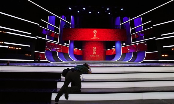 epa06359796 A photographer takes pictures of the stage on the eve of the FIFA World Cup 2018 Final Draw in the State Kremlin Palace in Moscow, Russia, 30 November 2017. The Final Draw for the FIFA Wor ...