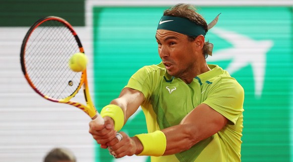 epa09975548 Rafael Nadal of Spain hits a backhand in the men&#039;s second round match against Corentin Moutet of France during the French Open tennis tournament at Roland Garros in Paris, France, 25  ...