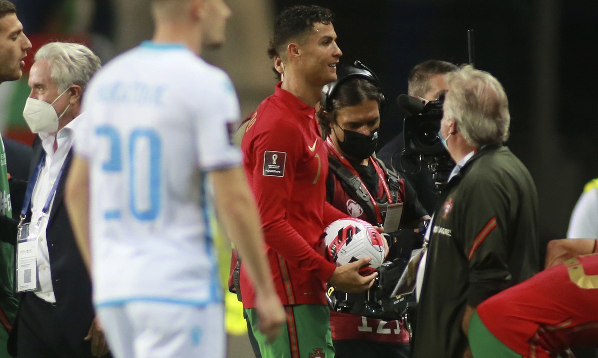 Portugal's Cristiano Ronaldo leaves the field with the match ball after scoring a hat-trick during the World Cup 2022 group A qualifying soccer match between Portugal and Luxembourg at the Algarv ...