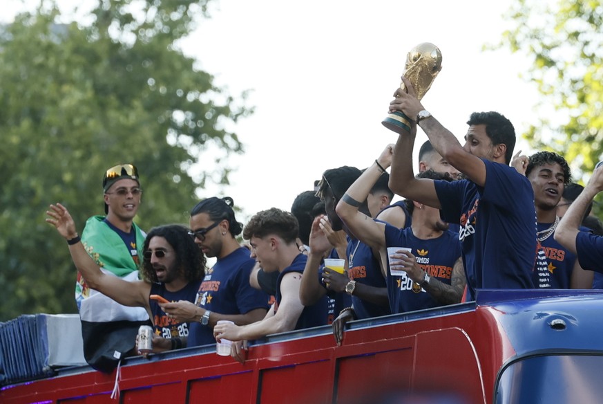 epa13123612 Spanish national soccer players Rodri holds the trophy as the team celebrates the FIFA World Cup win during an open-top bus parade in Madrid, Spain, 20 July 2026. Spain beat Argentina in t ...