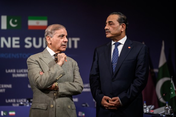 Pakistan's Prime Minister Muhammad Shehbaz Sharif, left, stands with Pakistan's Chief of Army Staff Field Marshal Asim Munir prior to a quadrilateral meeting between the United States, Iran, ...