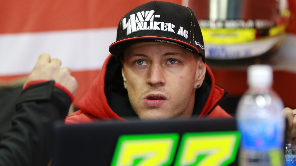 Moto2 rider Dominique Aegerter of Switzerland looks at a monitor during the free practice session for the MotoGP Japanese Motorcycle Grand Prix at the Twin Ring Motegi circuit in Motegi, north of Toky ...
