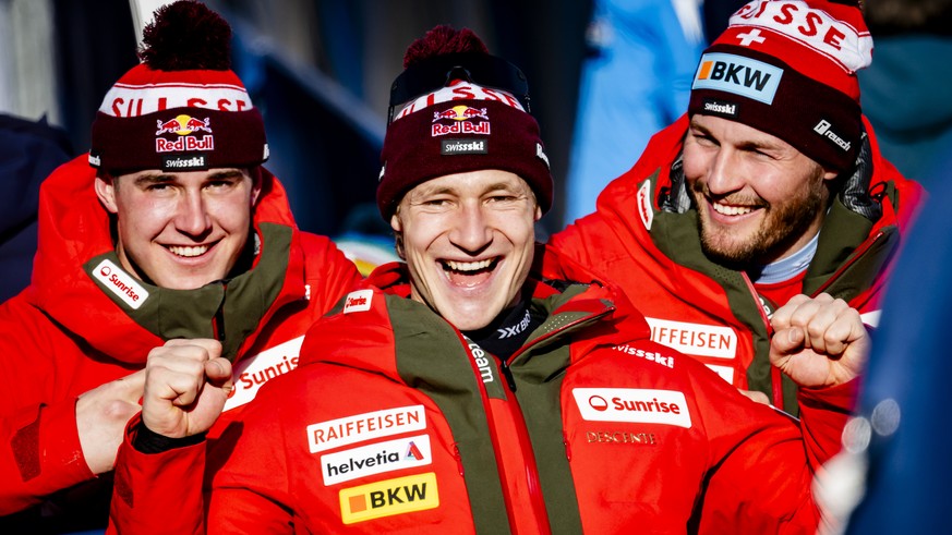 Franjo von Allmen, left, Marco Odermatt, center, and Alexis Monney, right, of Switzerland react in the finish area during the men&#039;s Super G race at the 2025 FIS Alpine World Ski Championships, in ...