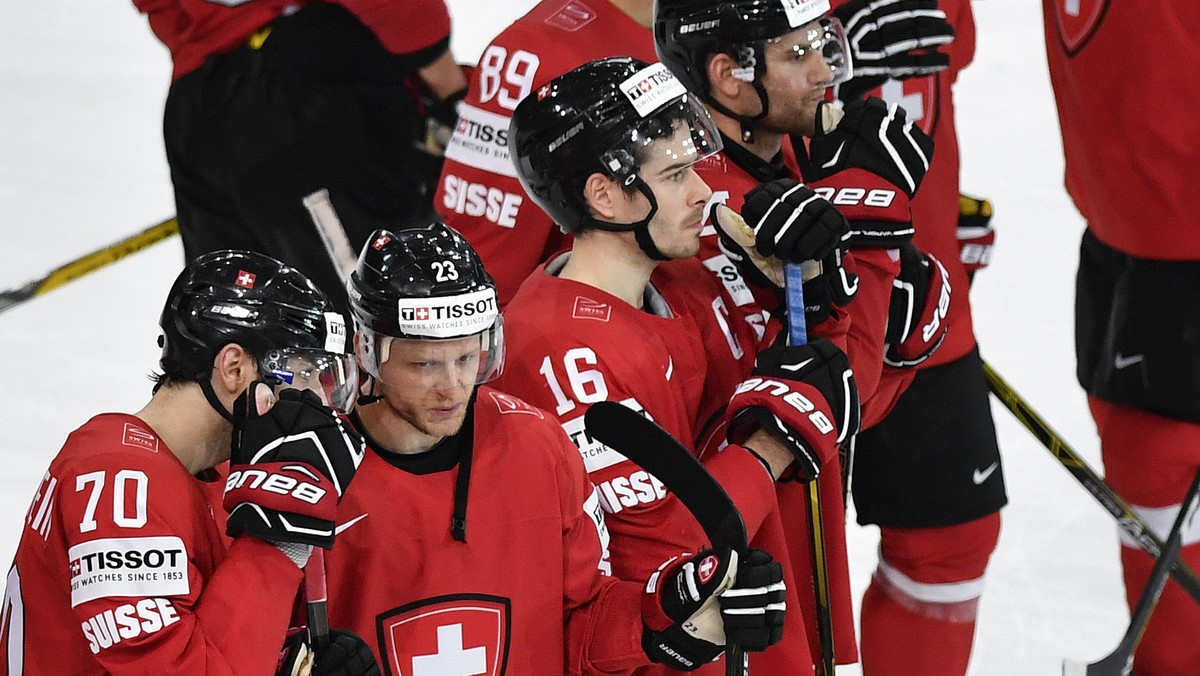 Switzerland's Denis Hollenstein, Simon Bodenmann and Rafael Diaz, from left, react after their Ice Hockey World Championship group B preliminary round match between Switzerland and France in Pari ...