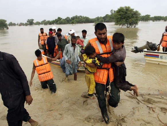 FILE - Army troops evacuate people from a flood-hit area in Rajanpur, district of Punjab, Pakistan, Aug. 27, 2022. Loss and damage is the human side of a contentious issue that will likely dominate cl ...