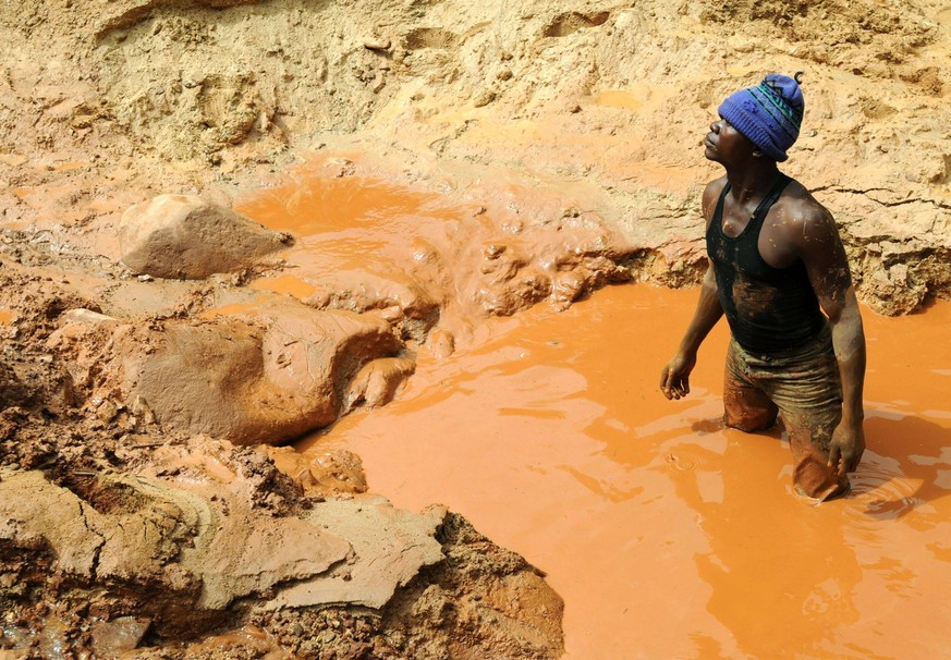 A man stands in a pool of water in a gold mine on February 23, 2009 in Chudja, near Bunia, north eastern Congo. The conflict in Congo has often been linked to a struggle for control over its resources ...