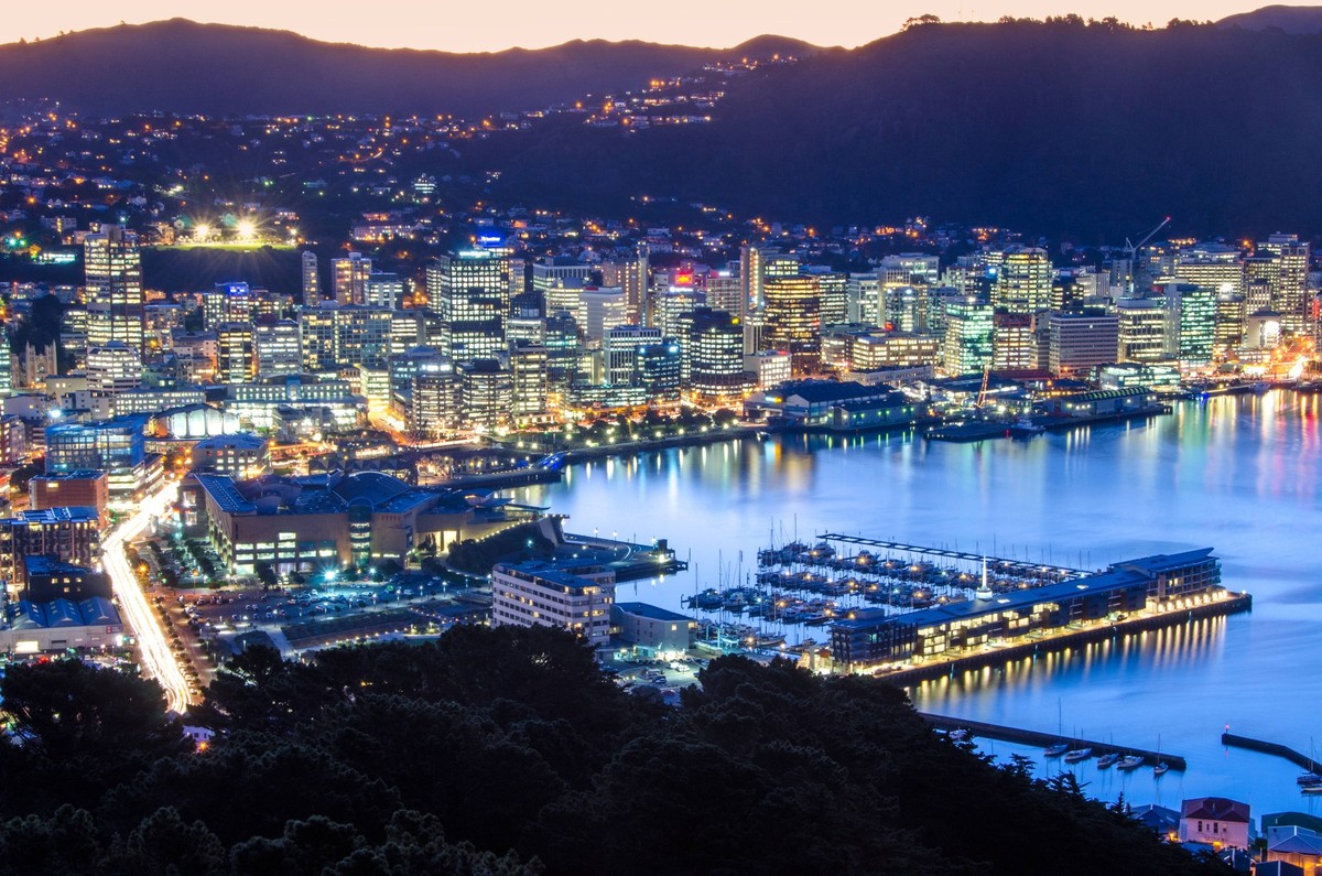 Aerial view of Wellington port with moored boats surrounded by mountains located in modern evening city with glowing buildings CesarAsensio_ID12607_383099_017 Copyright: xCesarxAsensiox
