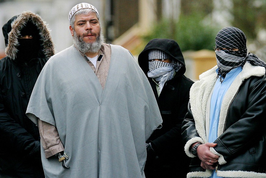 Muslim cleric Sheikh Abu Hamza (2nd L) is pictured surrounded by supporters outside the North London Mosque at Finsbury Park in this February 7, 2003 file photo. London imam Abu Hamza al-Masri was con ...