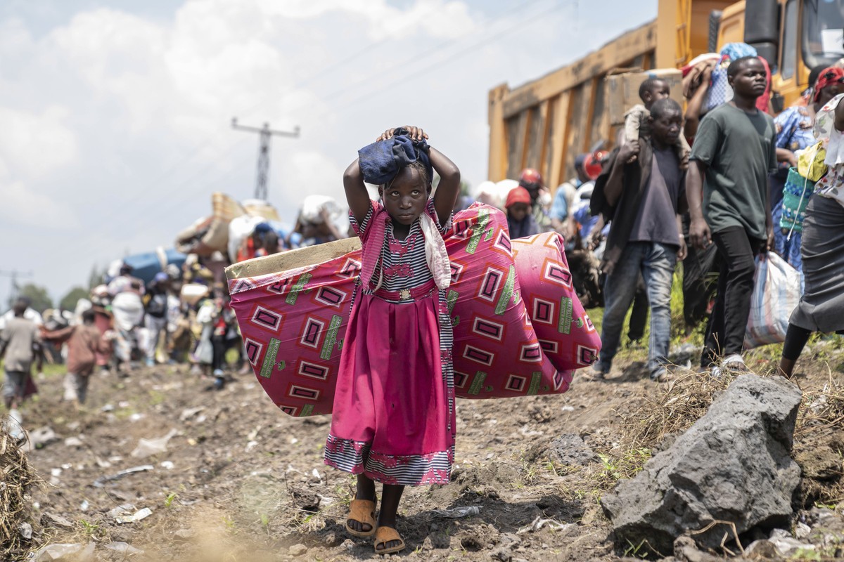 Thousands who are fleeing the ongoing conflict between government forces and M-23 rebels reach the entrance the Democratic Republic of Congo eastern city of Goma Wednesday, Feb. 7, 2024. (AP Photo/Mos ...