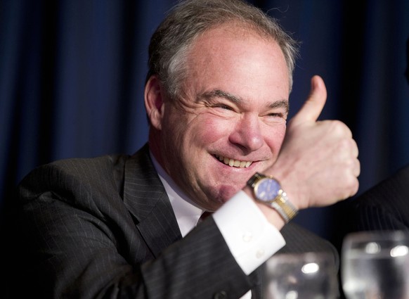 FILE - In this Feb. 4, 2016, file photo, Sen. Tim Kaine, D-Va., gives a &#039;thumbs-up&#039; as he takes his seat at the head table for the National Prayer Breakfast in Washington. Kaine is one of se ...