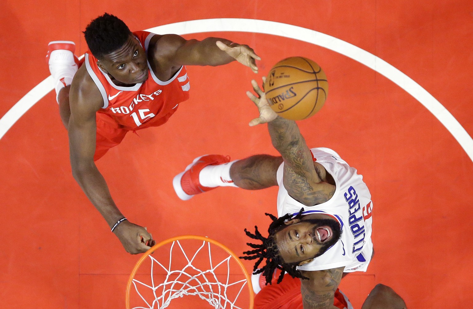 Houston Rockets center Clint Capela, left, of Switzerland, and Los Angeles Clippers center DeAndre Jordan reach for a rebound during the first half of an NBA basketball game Wednesday, Feb. 28, 2018,  ...