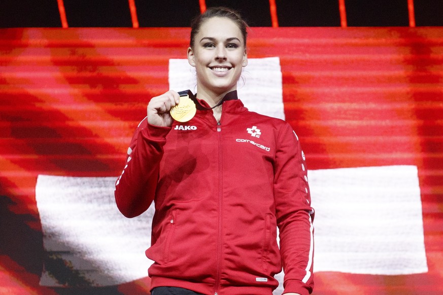 epa09156677 epa09156655 Gold medalist Switzerland&#039;s Giulia Steingruber celebrates on the podium after performing on the vault during the women&#039;s apparatus finals of the 2021 European Artisti ...