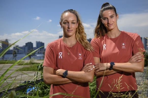 epa09355926 Swiss athletes in beach volleyball Joana Heidrich (R) and Anouk Verge-Depre pose for photographers after a virtual press conference at the 2020 Summer Olympics, in Tokyo, Japan, 21 July 20 ...