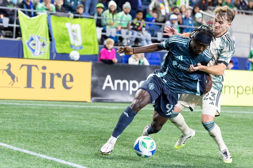October 4, 2025, Seattle, Washington, USA: Oct 4,, 2025 Seattle, Washington, USA .Seattle Sounders FC forward Georgi Minoungou 93 and Portland Timbers defender Ian Smith 23 fight for the ball in the s ...