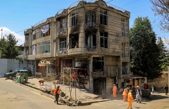 epa10020347 Muncipality workers clear the scene of an explosion in front of a Sikh temple, in Kabul, Afghanistan, 18 June 2022. Suicide attackers stormed a Sikh temple in the Afghan capital on 18 June ...