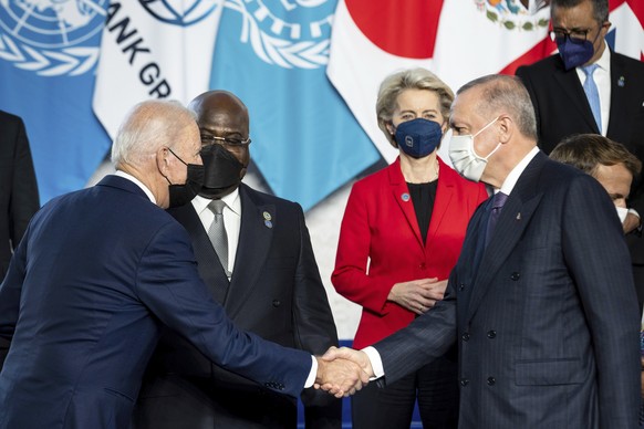 U.S. President Joe Biden, left, shakes hands with Turkish President Recep Tayyip Erdogan ahead of the opening session of the G20 summit at the La Nuvola conference center, in Rome, Saturday, Oct. 30,  ...