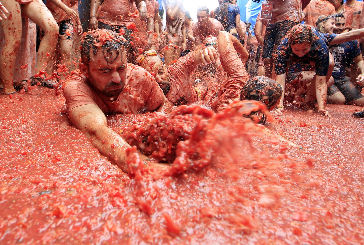 Revelers enjoy as they throw tomatoes at each other, during the annual "Tomatina", tomato fight fiesta, in the village of Bunol, 50 kilometers outside Valencia, Spain, Wednesday, Aug. 30, 20 ...