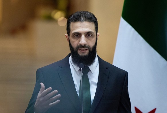 epa11790226 A handout photo made available by the Turkish Foreign Ministry Press Office shows Syria&#039;s rebel leader Ahmed al-Sharaa, also known as Abu Mohammed al-Jolani, attending a press confere ...