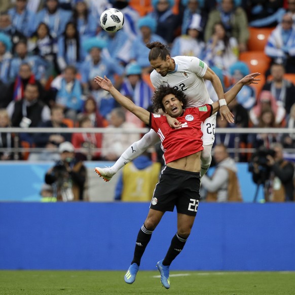Uruguay&#039;s Martin Caceres, top, and Egypt&#039;s Amr Warda challenge for the ball during the group A match between Egypt and Uruguay at the 2018 soccer World Cup in the Yekaterinburg Arena in Yeka ...