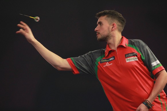 epa06410731 Welshman Jamie Lewis in action on the oche during the PDC World darts Semi-Final match against English Phil Taylor and at the Alexander Palace in North London, Britain, 30 December 2017. E ...