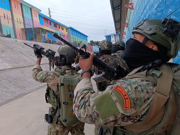 epa11065098 A handout photo made available by the Armed Forces of Ecuador shows Marine Infantry soldiers as they carry out an operation after a riot at the Litoral Regional Prison in Guayaquil, Ecuado ...