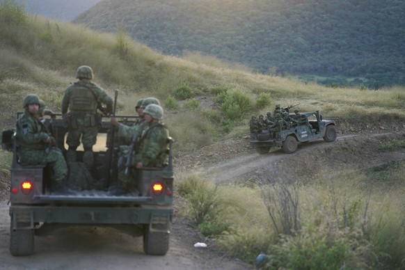 Soldiers patrol near the hamlet Plaza Vieja in the Michoacan state of Mexico, Thursday, Oct. 28, 2021. The Mexican army has largely stopped fighting drug cartels here, instead ordering soldiers to gua ...