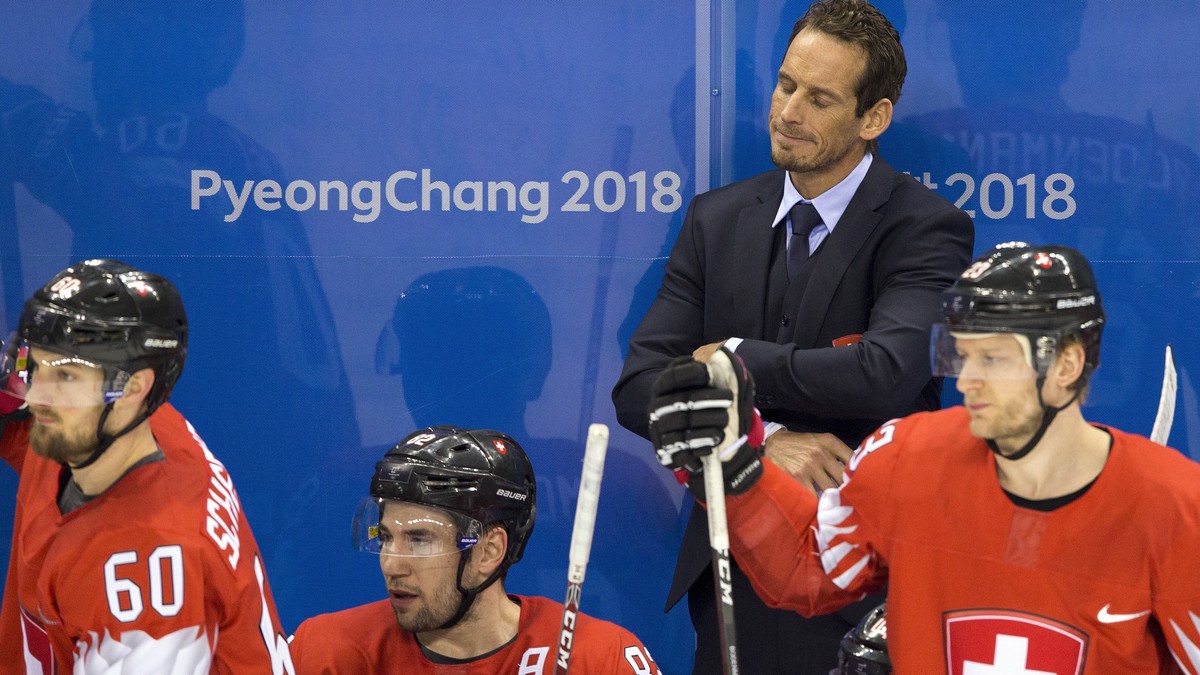 Tristan Scherwey of Switzerland, Simon Moser of Switzerland, Patrick Fischer, head coach of Switzerland, and Simon Bodenmann of Switzerland, from left, react after the men ice hockey play-off qualific ...