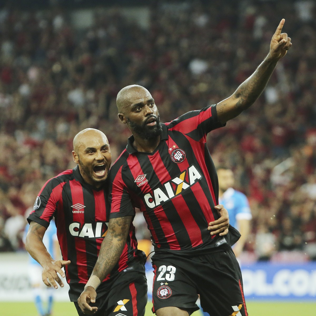 Grafite of Brazil's Atletico Paranaense, right, celebrates with teammate Jonathan, after scoring against Colombia's Millonarios, during a Copa Libertadores soccer match in Curitiba, Brazil,  ...