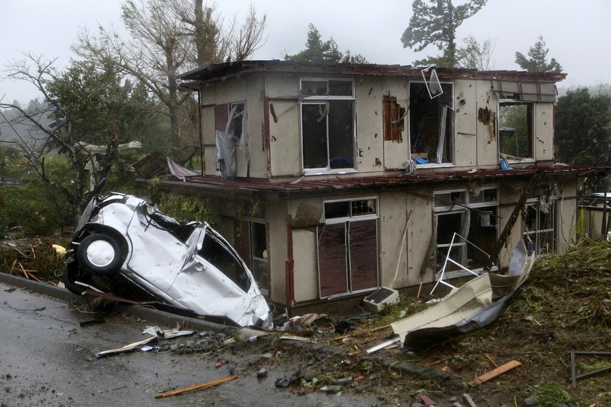 epaselect epa07914687 A view of a damaged vehicle and house after a tornado caused by typhoon Hagibis hit Ichihara, Chiba Prefecture, east of Tokyo, 12 October 2019. Tyhoon Hagibis is expected to make ...