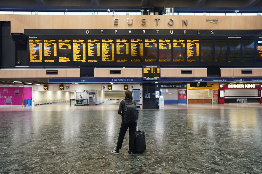 A passenger at Euston station in London looks at the departures board on the first day of a rail strike on Tuesday June 21, 2022. Britain&#039;s biggest rail strikes in decades went ahead Tuesday afte ...