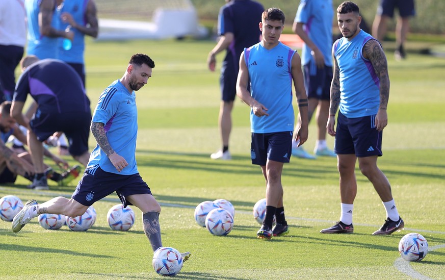epa10318019 Argentina captain Lionel Messi (L) in action during a training session of the team in Doha, Qatar, 21 November 2022. Argentina will face Saudi Arabia on 22 November in their group C match  ...