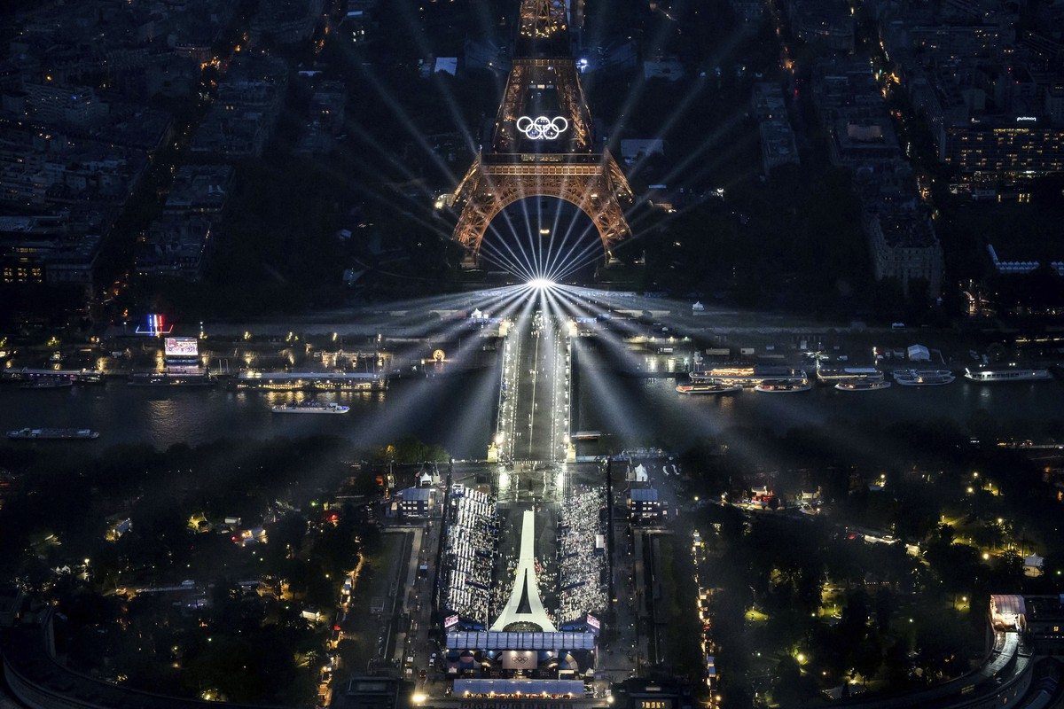The Eiffel Tower and the Olympics rings are lit up during the opening ceremony for the 2024 Summer Olympics in Paris, France, Friday, July 26, 2024. (Lionel Bonaventure/Pool Photo via AP)