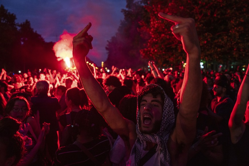 EDS NOTE: OBSCENITY - People gather at Republique plaza to protest the far-right National Rally, which came out strongly ahead in first-round legislative elections, Sunday, June 30, 2024, in Paris. Fr ...