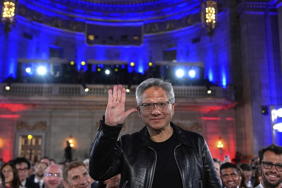 Nvidia CEO Jensen Huang waves as President Donald Trump speaks during an AI summit at the Andrew W. Mellon Auditorium, Wednesday, July 23, 2025, in Washington. (AP Photo/Julia Demaree Nikhinson)
Trump ...