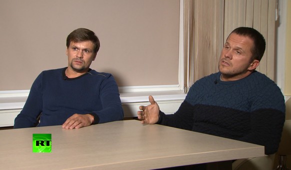FILE - In this video grab provided by the RT channel on Thursday, Sept. 13, 2018, Ruslan Boshirov, left, and Alexander Petrov attend their first public appearance in an interview with the RT channel i ...