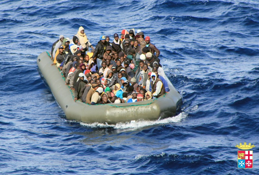 epa04058247 A handout video-grab released by Italian Navy Press Office on 06 February 2014 shows a boat with African migrants on board spotted by the Navy at sea near Lampedusa, Italy, 05 February 201 ...